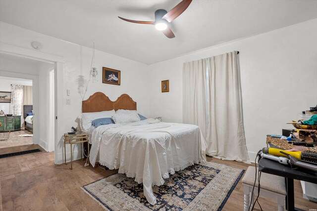 bedroom with ceiling fan and wood finished floors