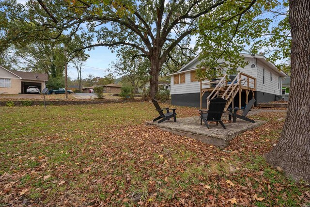 view of yard featuring stairs and an outdoor fire pit