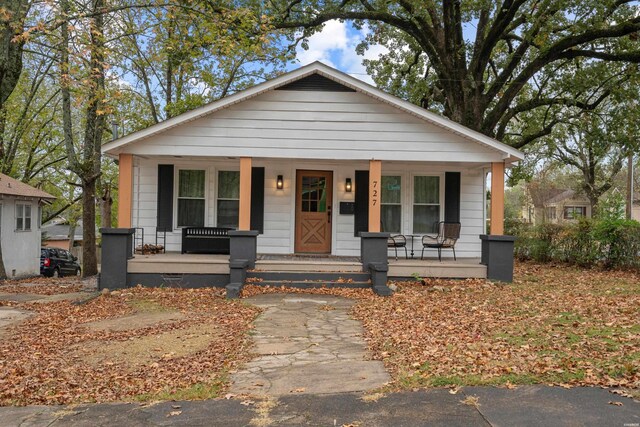 bungalow-style house with a porch and crawl space