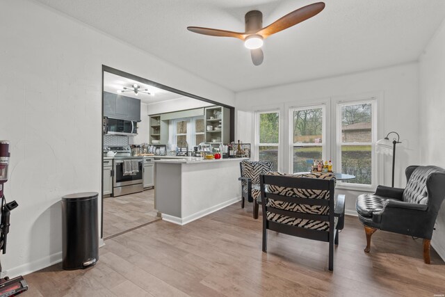 dining space with light wood-style floors, ceiling fan, and baseboards