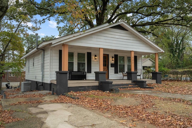 bungalow with covered porch, central AC unit, and crawl space