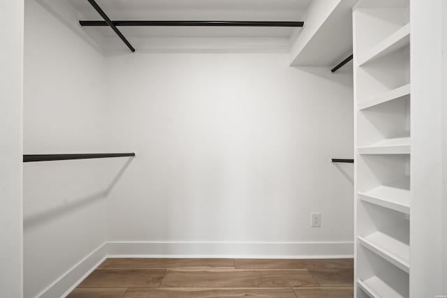 walk in closet featuring dark wood-style flooring