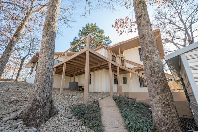 rear view of house with a deck and cooling unit