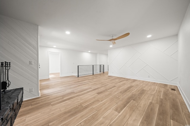 living area with baseboards, light wood-type flooring, a ceiling fan, and recessed lighting