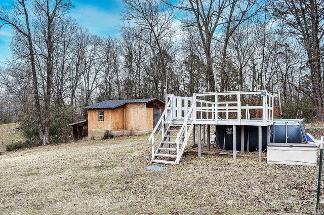 rear view of property with a sunroom and stairway