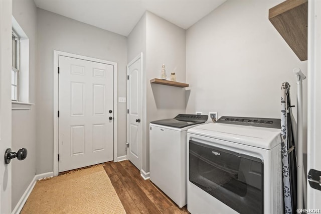 washroom featuring dark wood-style flooring, washer and clothes dryer, laundry area, and baseboards