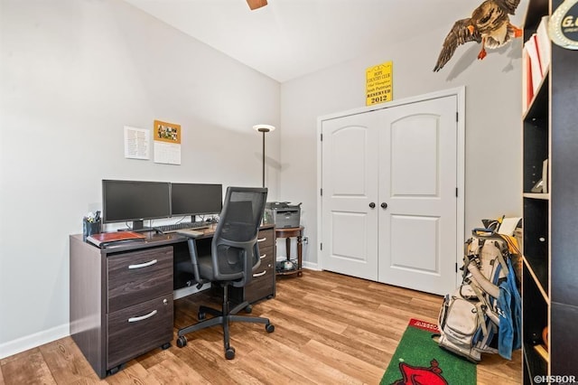 office area featuring light wood-style floors, baseboards, and a ceiling fan