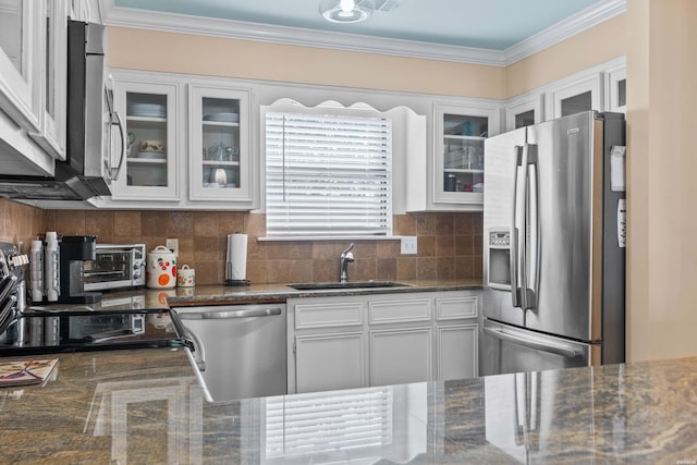 kitchen featuring white cabinets, glass insert cabinets, and stainless steel appliances