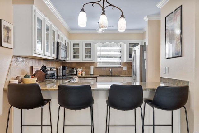 kitchen featuring white cabinetry, appliances with stainless steel finishes, glass insert cabinets, and stone countertops