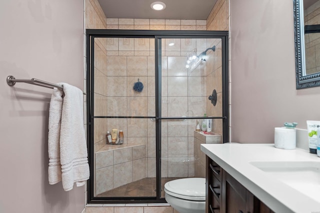 full bathroom with toilet, a shower stall, and vanity