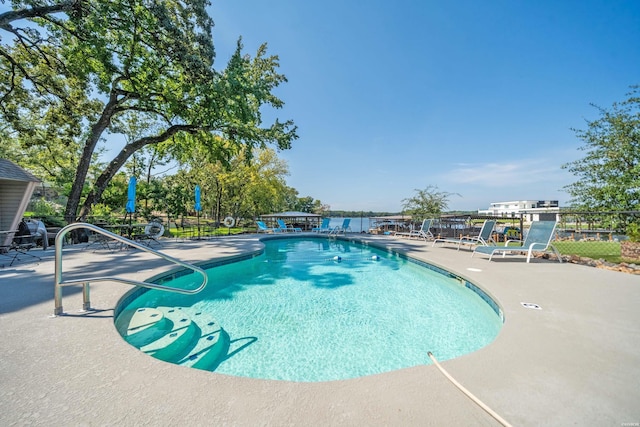 pool featuring a patio and fence