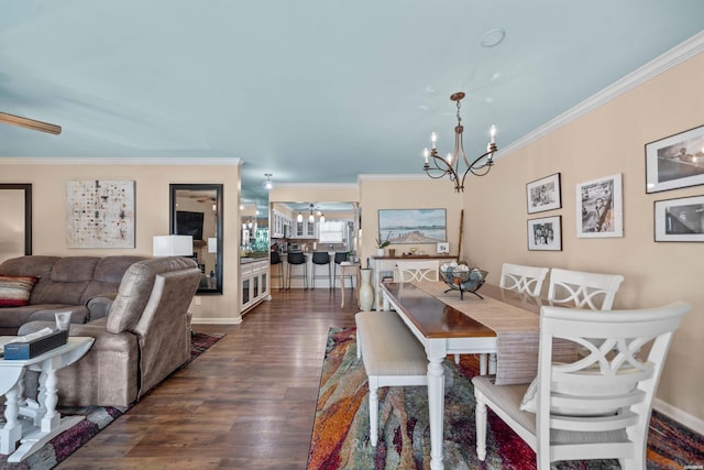 dining room with ceiling fan with notable chandelier, baseboards, dark wood finished floors, and crown molding