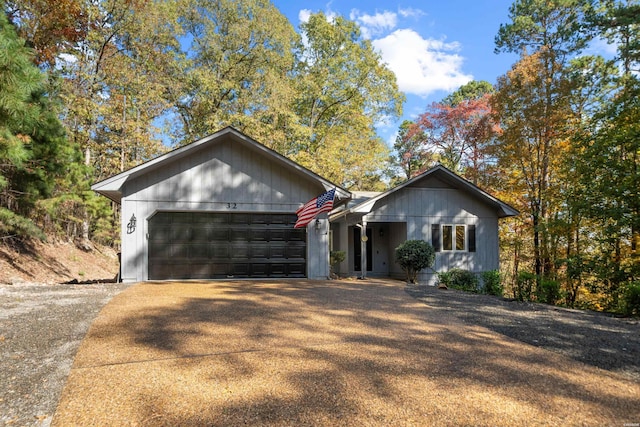 ranch-style home featuring an attached garage and concrete driveway