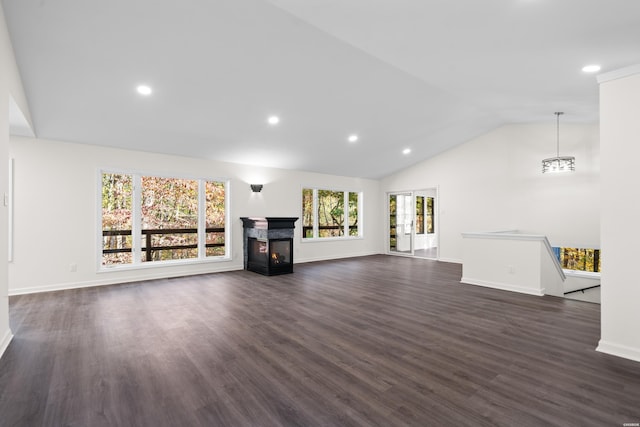 unfurnished living room with dark wood finished floors, lofted ceiling, recessed lighting, a multi sided fireplace, and baseboards