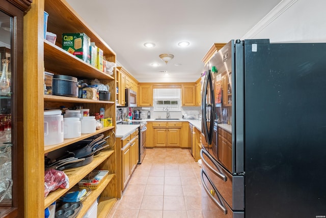 kitchen featuring light tile patterned floors, stainless steel appliances, light countertops, open shelves, and a sink