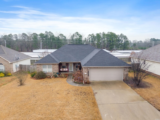 single story home with driveway, a shingled roof, an attached garage, and brick siding