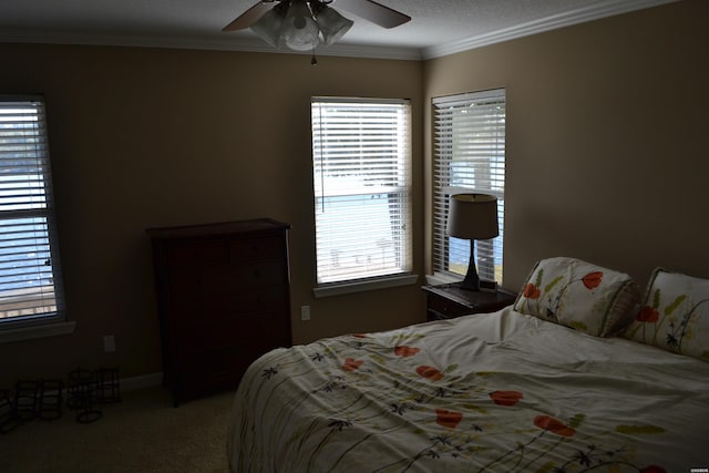 bedroom with carpet floors, ornamental molding, and ceiling fan