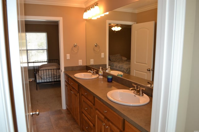 bathroom featuring ornamental molding, double vanity, a sink, and ensuite bathroom