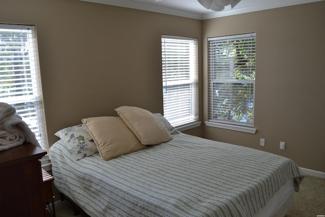 bedroom featuring multiple windows, carpet, and crown molding