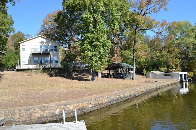 view of dock with a water view and a gazebo