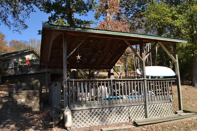 view of property's community with a gazebo and a wooden deck