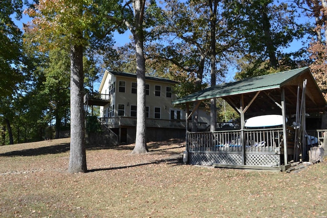 exterior space with metal roof, a deck, and a gazebo