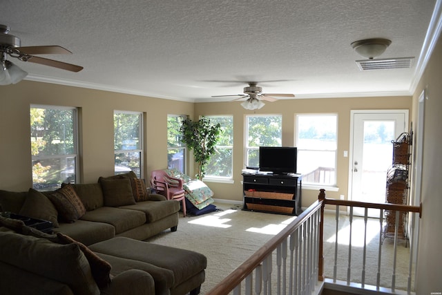 carpeted living room featuring ornamental molding, visible vents, a textured ceiling, and baseboards