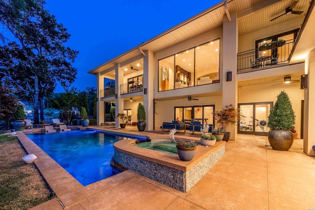 view of swimming pool featuring ceiling fan, a patio, and a pool with connected hot tub