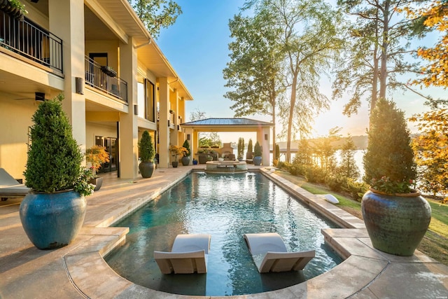 view of swimming pool featuring a gazebo, a patio, and a pool with connected hot tub