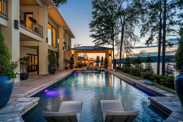 view of swimming pool featuring a pool with connected hot tub and a gazebo