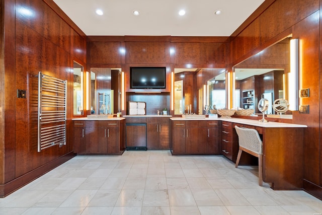 bathroom with radiator, wood walls, recessed lighting, and vanity