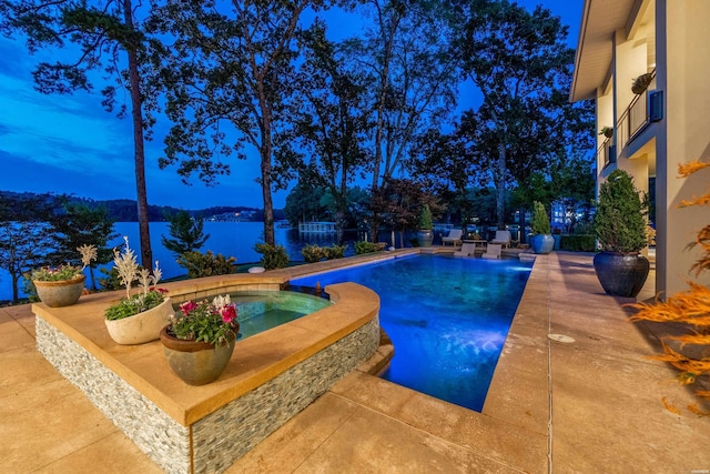 view of pool featuring a patio and a pool with connected hot tub