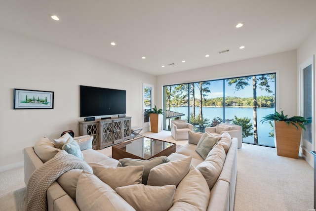 living room with baseboards, recessed lighting, visible vents, and light colored carpet