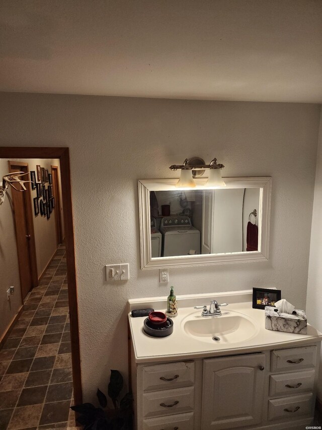 bathroom with washer and clothes dryer and vanity