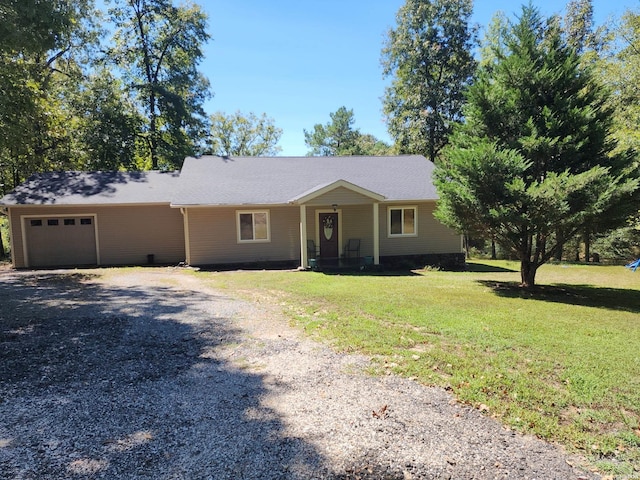 ranch-style house with a garage, a front lawn, and gravel driveway