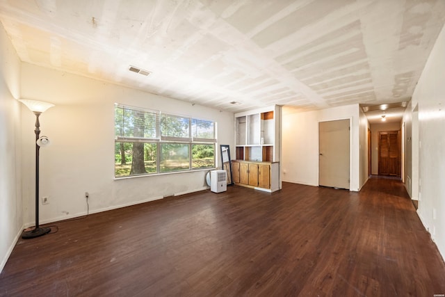 124 Primrose Ln, Pearcy, AR 71964 - unfurnished living room featuring dark wood-style floors and baseboards