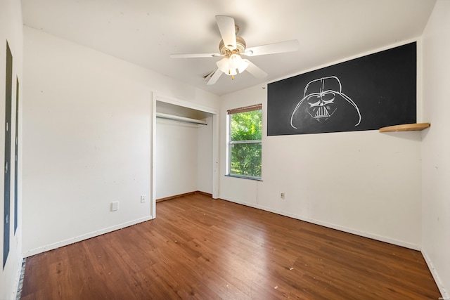 124 Primrose Ln, Pearcy, AR 71964 - unfurnished bedroom featuring wood finished floors, baseboards, a closet, and ceiling fan