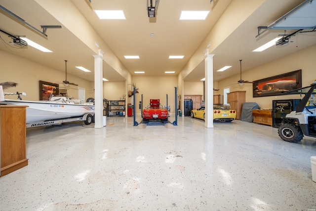 garage with a ceiling fan and a garage door opener