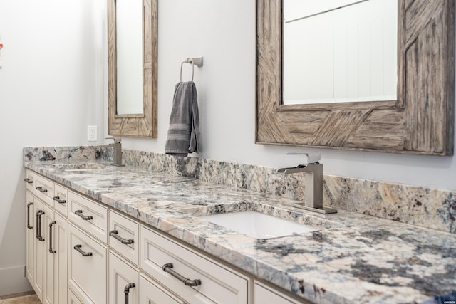 bathroom featuring a sink and double vanity