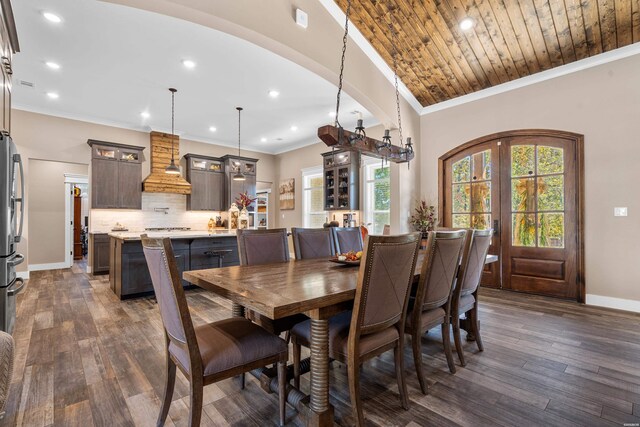 dining space with baseboards, arched walkways, dark wood finished floors, and french doors