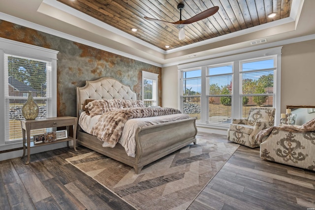 bedroom with a tray ceiling, wooden ceiling, visible vents, and multiple windows