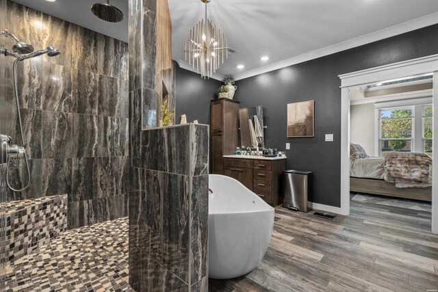 ensuite bathroom featuring a freestanding tub, ornamental molding, a walk in shower, and wood finished floors