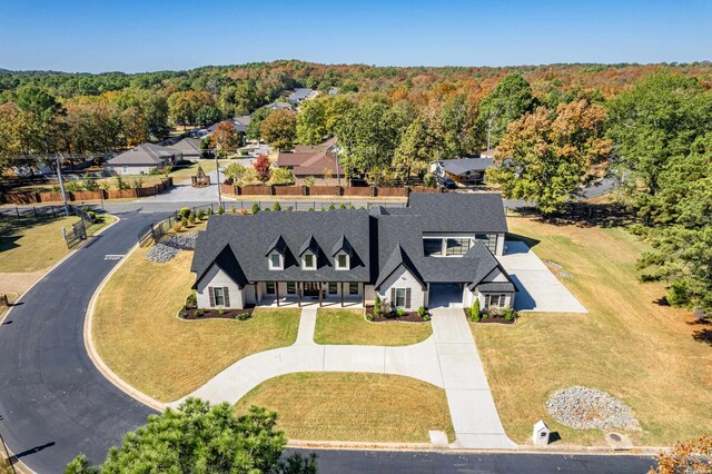 birds eye view of property with a forest view and a residential view