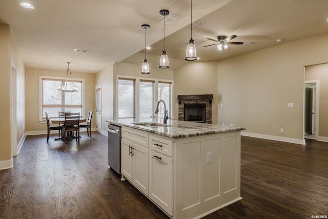 kitchen with open floor plan, stainless steel dishwasher, a sink, and visible vents