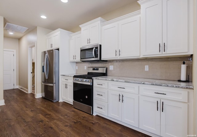 kitchen with dark wood-style flooring, visible vents, backsplash, appliances with stainless steel finishes, and white cabinets