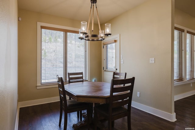 dining room featuring dark wood-style floors, a chandelier, and baseboards