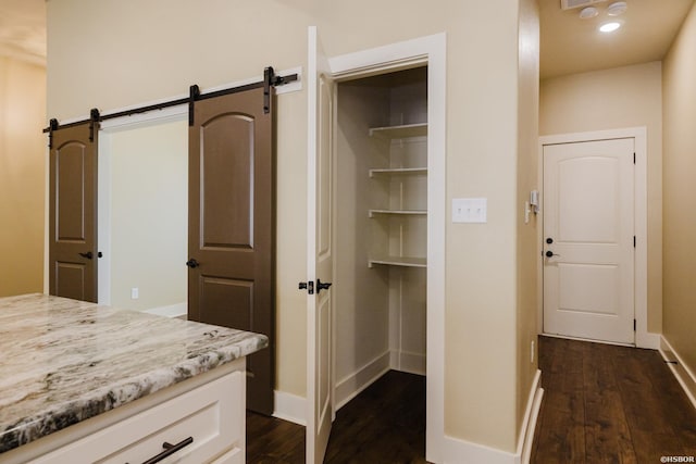 interior space with baseboards and wood finished floors