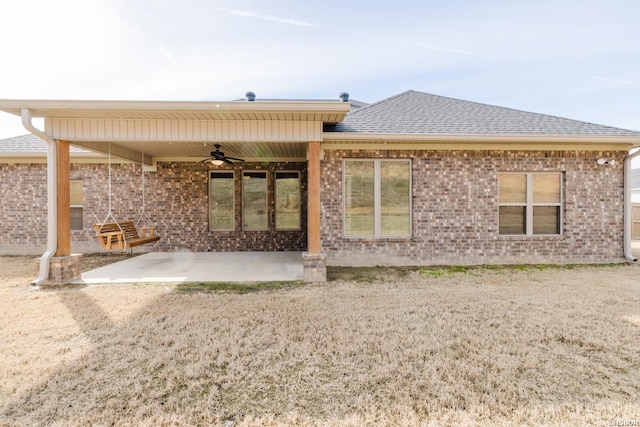 back of house with ceiling fan, a patio, brick siding, and a shingled roof