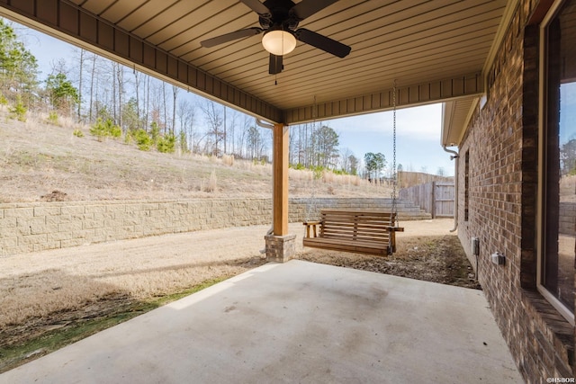 view of patio / terrace with ceiling fan and fence