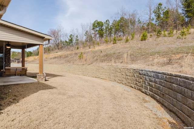 view of yard with a ceiling fan and a patio